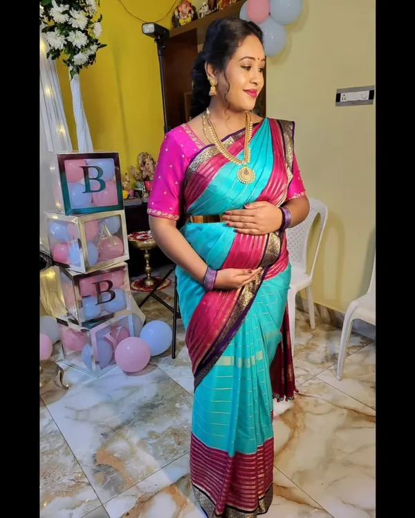 For this mom-to-be's baby shower, I styled a vibrant Mysore silk saree to be both beautiful and comfortable. The drape is adjusted to gracefully accommodate the baby bump, ensuring she feels secure and celebrated.