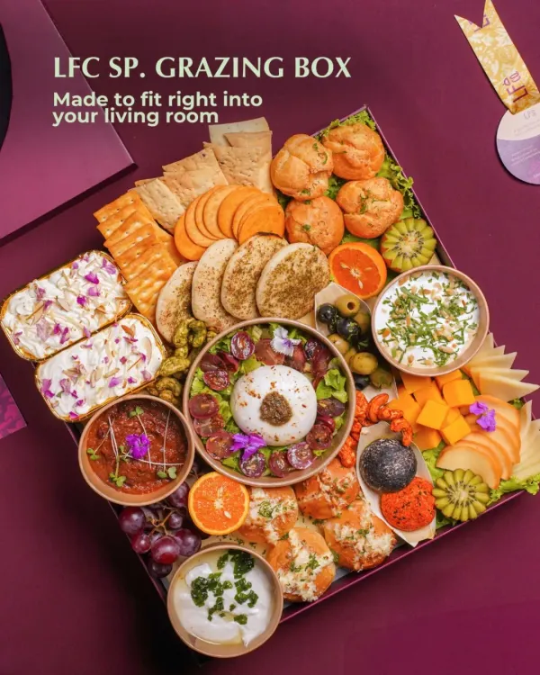 This is my signature Grazing Box, designed to be the effortless centerpiece of your living room gathering. It's generously packed with a curated selection of artisanal cheeses, creamy Burrata, fresh fruits, savory dips, and assorted crackers, making it a complete, ready to serve feast.