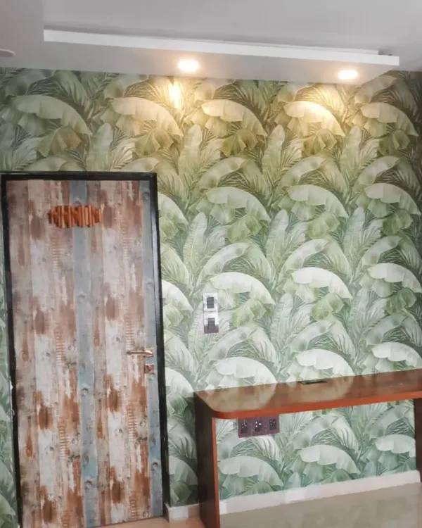 A vibrant banana leaf wallpaper that makes a bold statement in this study nook. The lush green pattern creates a fresh and energetic atmosphere.