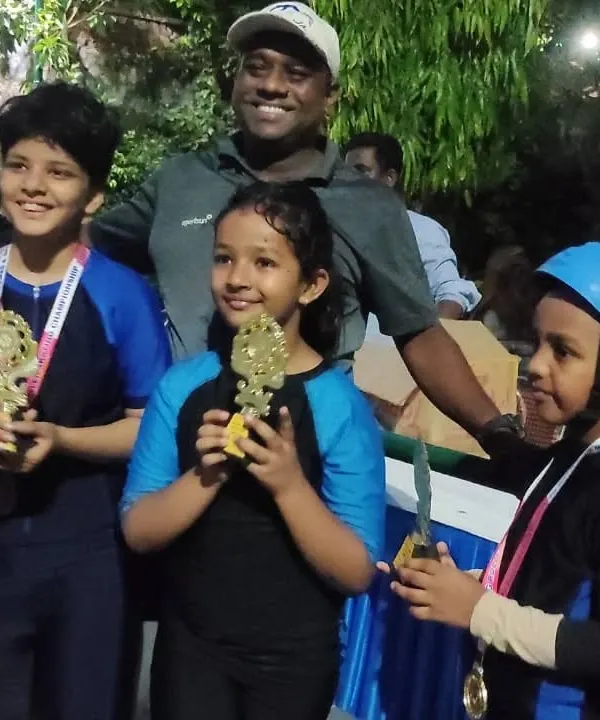 Celebrating our winners. These students are proudly showing off the trophies and medals they earned through their hard work and competitive spirit.