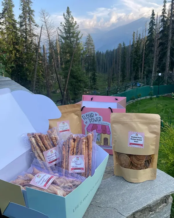 My travel-friendly snack box, featuring an assortment of gluten-free goodies. This box includes everything-seasoning breadsticks, parmesan cheese straws, and jaggery makhana.