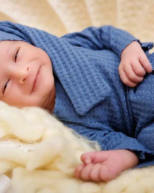 A newborn's smile is the most magical thing in the world. This is a perfect example of the peaceful, happy moments I strive to capture during my newborn sessions.