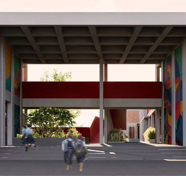 The main entrance of the school in Mandya is designed as a welcoming, double-height portal. The exposed coffered slab and colorful murals add visual interest, creating an inspiring gateway for students and the community.