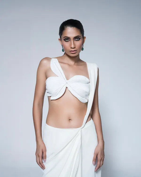 This look captures my passion for modern, minimalist design. I styled this contemporary draped saree to create a clean, sculptural silhouette, perfect for a client seeking understated elegance for a cocktail party or high-fashion event.