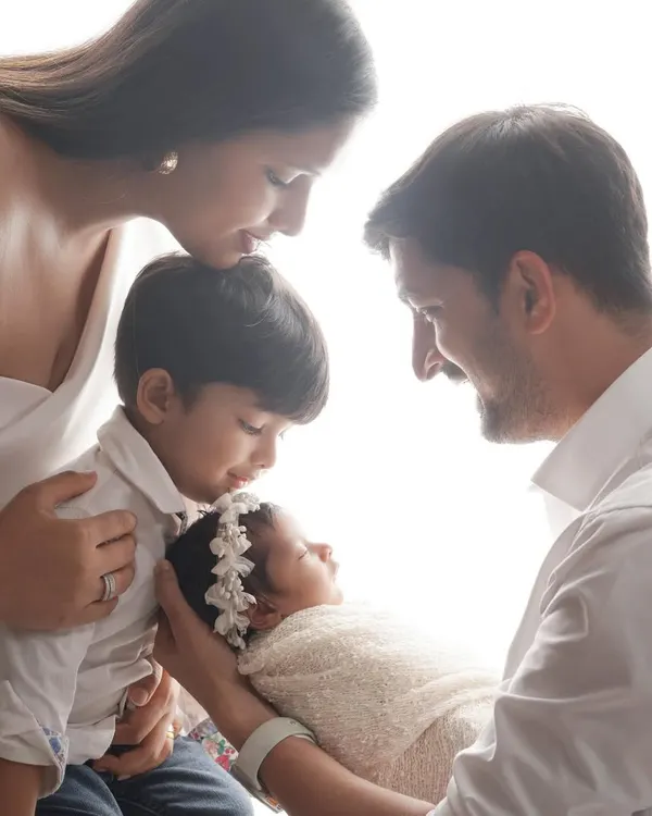 A tender moment as a big brother and loving parents gaze at their newest family member. This is what it's all about: capturing the pure, unscripted love that fills the room when a family grows.