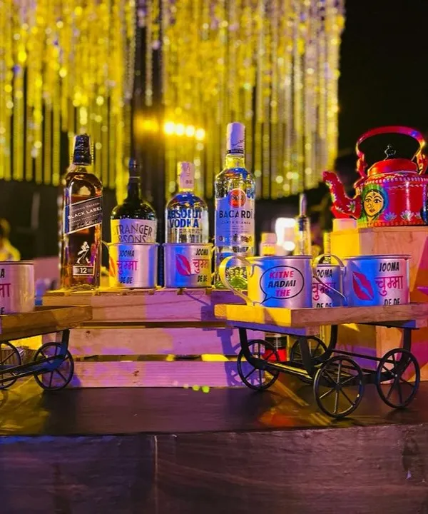 My Bollywood themed bar setup in full swing. I use props like miniature handcarts and custom-printed cans with movie dialogues to display liquor, creating a fun and immersive experience for all the film buffs.