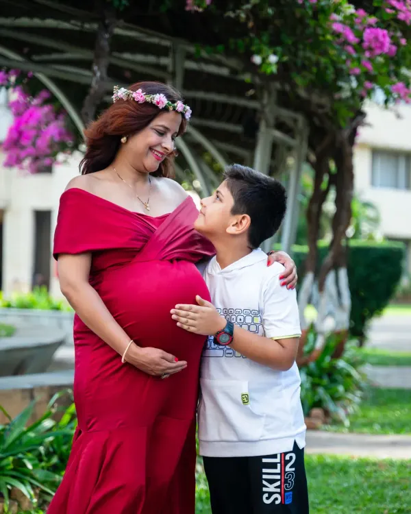 A heartwarming portrait of a mom-to-be and her son. The way he looks at her and touches her belly shows his excitement to become a big brother.