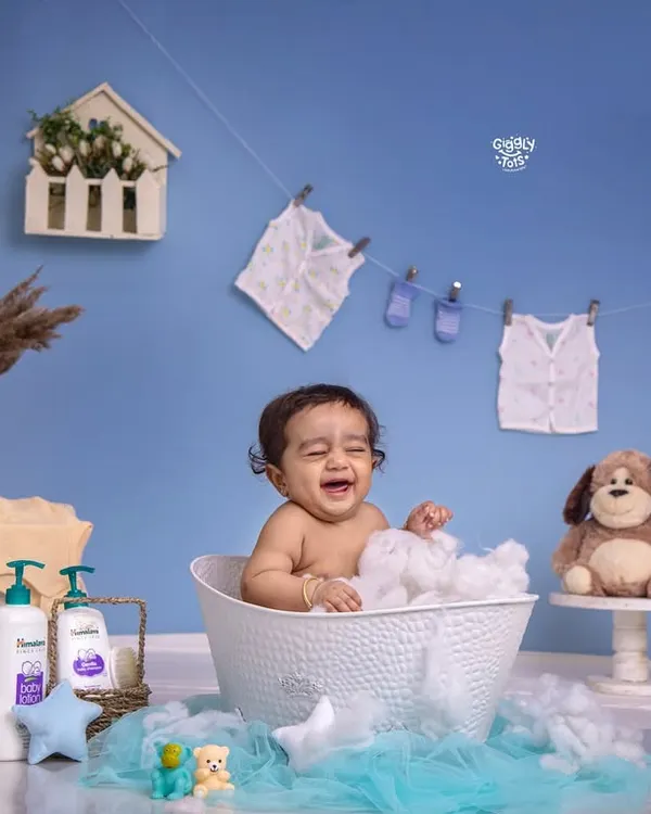 Bath time giggles are the best! This little one is having a wonderful time splashing around in a tub full of bubbles.