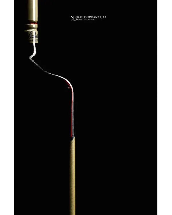 An abstract and minimalist take on a wine bottle. I used rim lighting to trace the elegant curve of the bottle against a pure black background, turning a simple product into a piece of art.