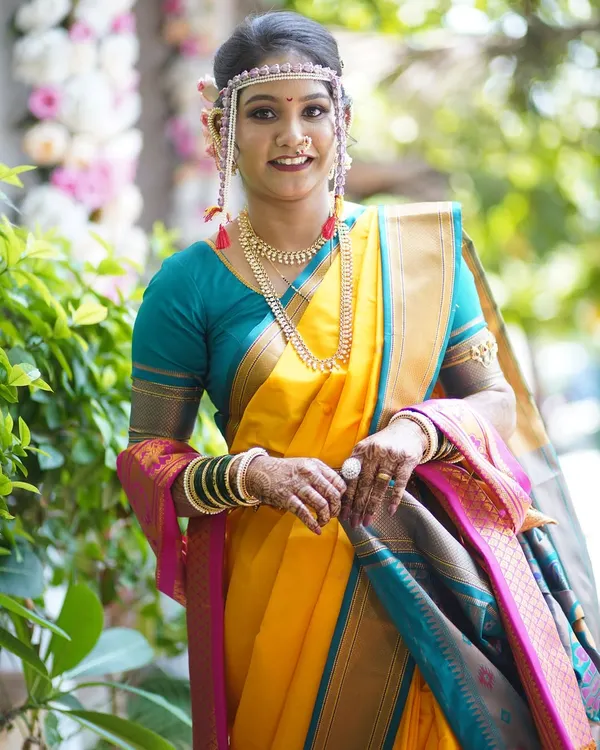 A full-length view of a bride in a yellow Nauvari saree, ready for her Vidhi ceremony. My service includes professional saree draping that is both beautiful and comfortable.