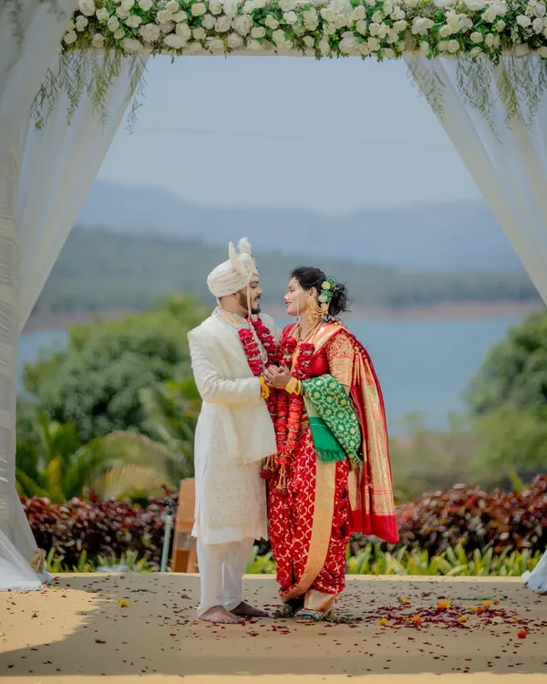 A quiet moment for the bride and groom, framed by a beautiful floral mandap against a serene lakeside backdrop. This is the kind of destination wedding photography I love, where nature becomes part of your story.