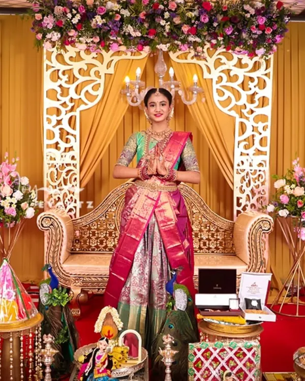 We designed this magnificent stage for a half saree ceremony, creating a truly royal setting. The setup features an ornate golden throne, intricate laser-cut panels, and lush floral arrangements to make the day unforgettable.