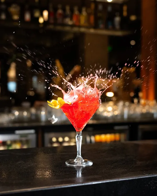 I love capturing the energy of a great cocktail. This dynamic splash shot freezes a moment of action, highlighting the vibrant color and refreshing feel of the drink, making it perfect for a bar's menu or social media.