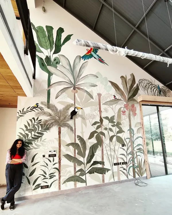 I believe a single mural can completely change the energy of a space. This large-scale tropical rainforest mural, for a private residence's double-height wall, was a joy to create, bringing the outdoors inside with layers of lush foliage and vibrant wildlife.