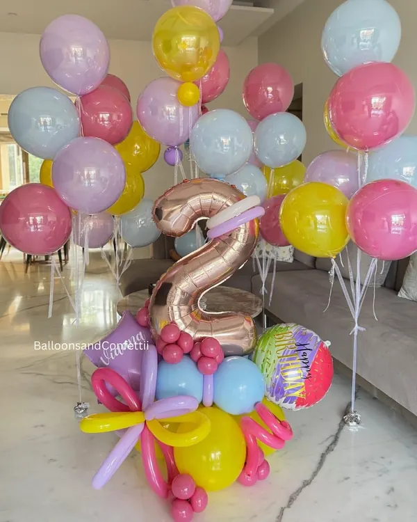 Every balloon tells a story, and this one says "I'm TWO!" A bright and cheerful balloon bouquet featuring a large rose gold number '2' and a mix of colorful latex balloons.