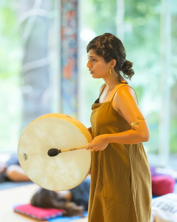 Using a frame drum during a sound healing session. The deep, resonant vibrations of the drum can be incredibly grounding, helping to bring you fully into the present moment.
