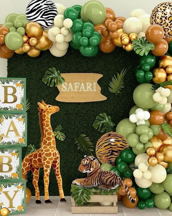 Welcome to the jungle. This safari-themed baby shower features a lush green backdrop, animal print balloons, and friendly giraffe and tiger props. The "BABY" blocks add a classic touch to this wild and fun celebration.