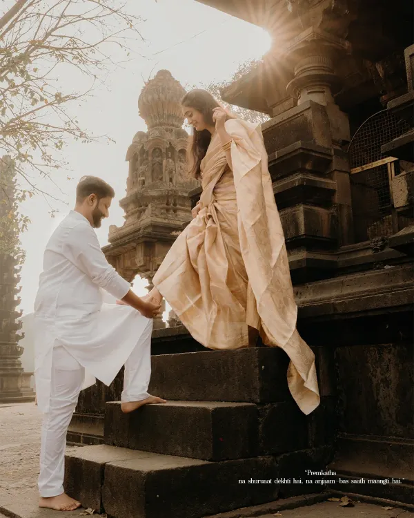 A timeless 'premkatha' moment. Against the backdrop of ancient temple architecture, he helps her up the steps, a simple gesture of care that speaks volumes. This is the kind of cinematic, soulful storytelling I love to capture.