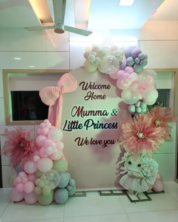 A sweet and simple welcome home setup for a little princess. This decoration features a pastel balloon garland, a cute bunny prop, and a personalized backdrop, perfect for a cozy corner in your home.