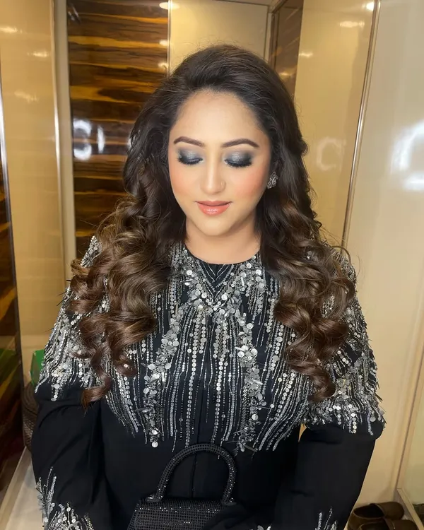 The perfect cocktail glam. This look features a beautifully blended silver and grey smokey eye, paired with soft, voluminous curls for an evening of elegance.