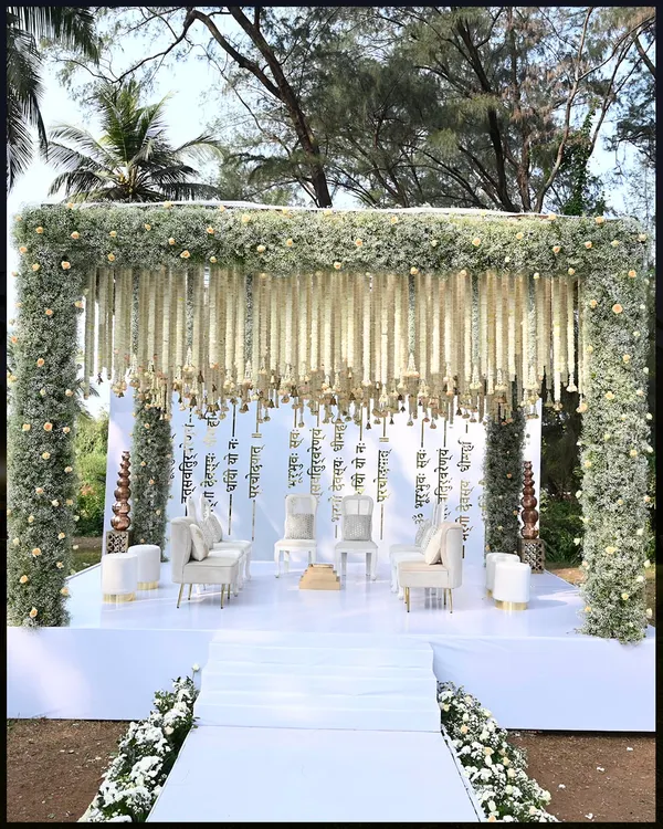 This ethereal wedding mandap at ITC Goa was a heavenly sight. Draped in pristine white florals with a backdrop of Sanskrit verses, it created a serene and sacred space for the couple to exchange vows.