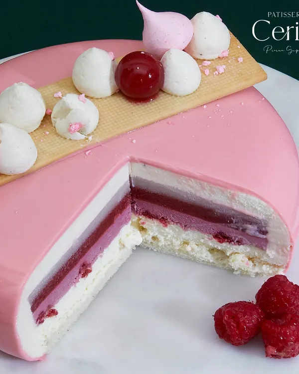 My Explosion of Berries entremet is a delightful symphony of flavours and textures. This cross section shows the vibrant sweetness of strawberries and raspberries, the exotic touch of lychee, and the smooth richness of vanilla.