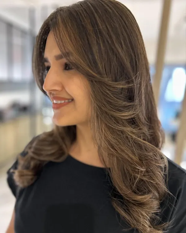A beautiful new look featuring curtain bangs and face-framing layers. I also added a three-tone hair color to create a blended, dimensional effect that perfectly complements the cut.