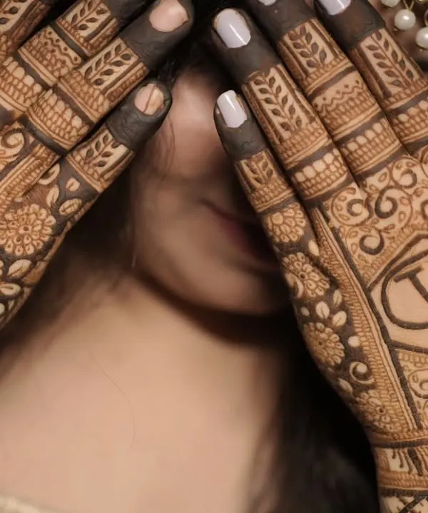 A simple yet elegant way to personalize your mehendi. This design features the couple's initials "AV" enclosed in a geometric crest on the back of the hands.