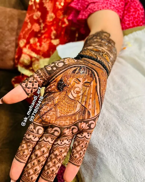 A beautiful portrait of a bride in her wedding attire, intricately detailed in henna on the palm. This is a wonderful way to personalize your bridal mehndi.