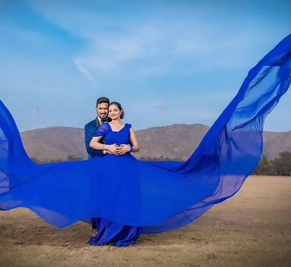 This is what I love to create, a fairytale moment for your pre-wedding shoot. This royal blue trail gown is one of my signature pieces, designed to make a statement against any backdrop. The way the fabric catches the wind is just magical.