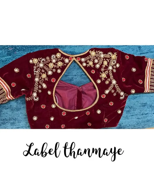 A rich maroon velvet blouse with heavy zardozi and bead embroidery. This kind of blouse is perfect for a bridal trousseau.