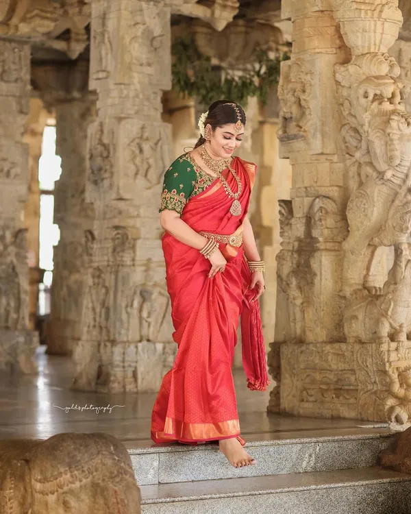 A candid moment of joy captured within the historic corridors of a temple. The bride's laughter echoes against the ancient stone, creating a beautiful contrast.
