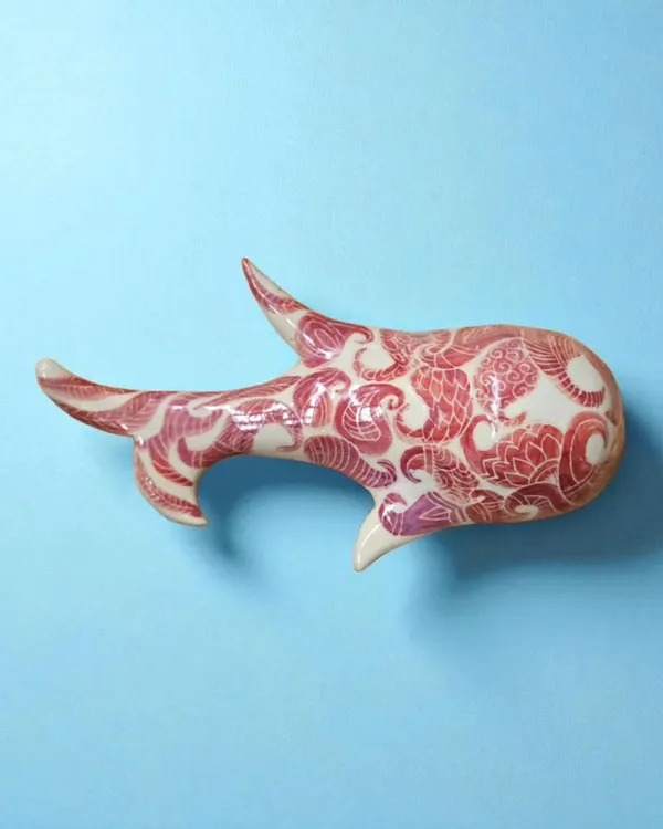 This fish wall sculpture, hand-painted in red, is a timeless symbol of wealth, fertility, and good fortune. It represents life's continuous flow and the promise of abundance.