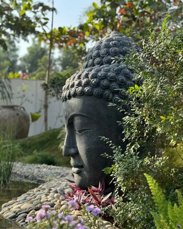 This is what we mean by creating a sanctuary. Our hand-carved 'Lama Buddha' head, crafted from lavastone, becomes the tranquil centerpiece of this stunning garden pond, bringing a sense of peace and mindfulness to the space.