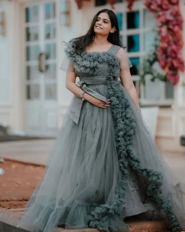 Make a statement at your next event with this elegant grey frill gown. The detailed ruffles and flattering silhouette make it a showstopper for pre-wedding events, birthday parties, or cocktail nights.
