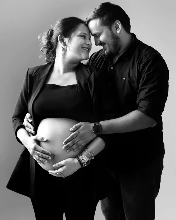 A classic black and white portrait that’s full of love. The couple’s happy expressions and the way they hold the baby bump together make this a truly heartwarming and timeless image.