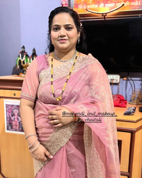 A full-length view of a party-ready look. This client wanted soft, nude makeup with a simple hairstyle and saree draping for a family function.