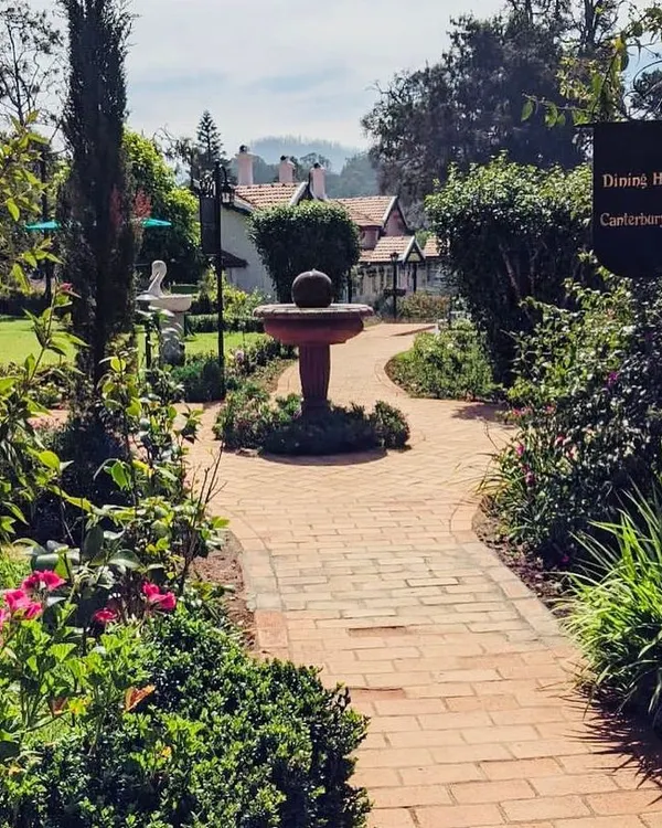 We had the privilege of redesigning the landscape for the historic Taj Savoy hotel in Ooty. This brick pathway leads through a classic English-style garden with a central fountain.