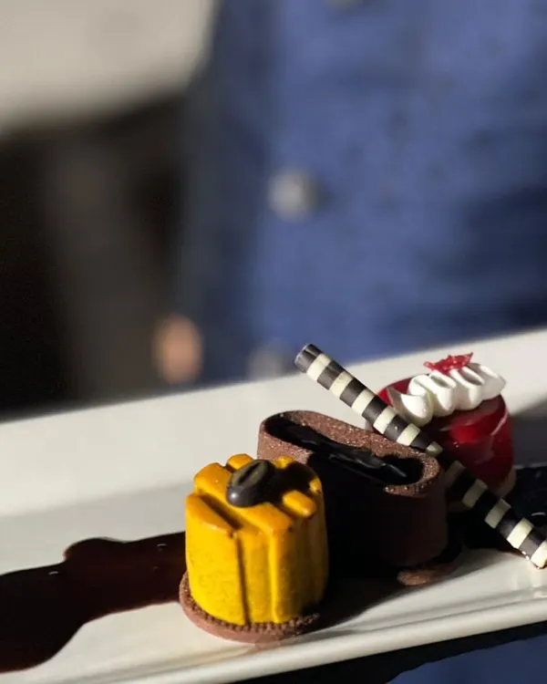 Dessert should be a work of art. This plated trio, featuring chocolate, fruit, and coffee elements, is designed for a sophisticated sit-down dinner where every course is a statement.
