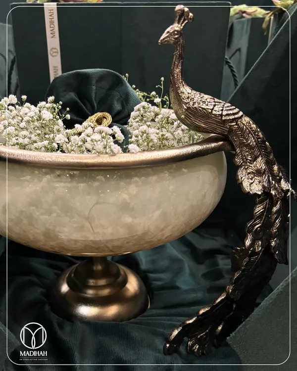 This is the art of gifting, reimagined. My signature Peacock Bowl, filled with delicate baby's breath, is more than a gift; it's a statement of grace and prosperity, designed to be a cherished centerpiece in your guests' homes.