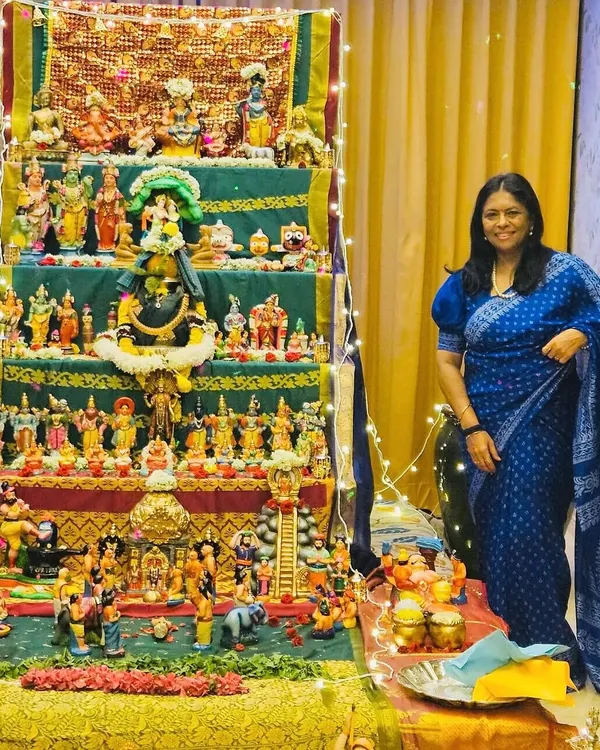 Celebrating the Dasara doll festival in a beautiful royal blue bandhani saree. The vibrant colors of the dolls and the saree reflect the deep traditions of Navratri.