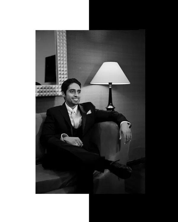 A classic black and white portrait of the groom, Wazir, looking relaxed and happy.
