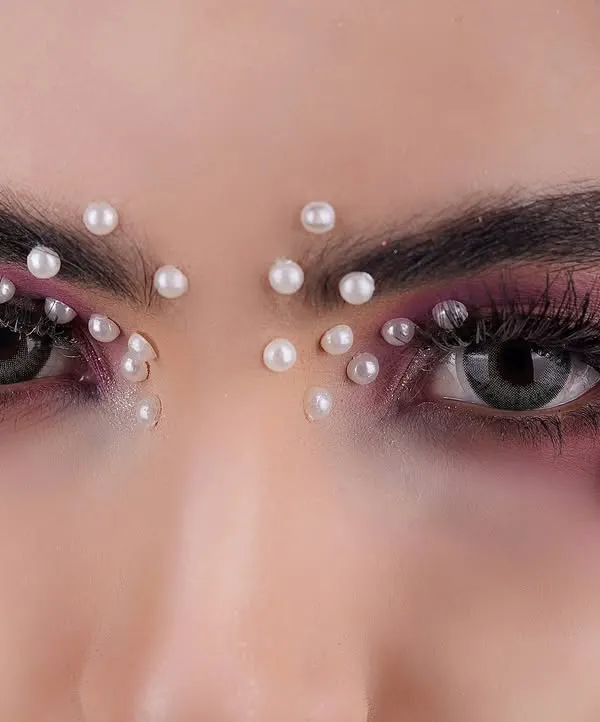 This is where beauty and art meet. I used macro techniques to capture the delicate details of the makeup, from the individual pearls to the texture of the flower petals, creating a powerful image for this beauty product campaign.