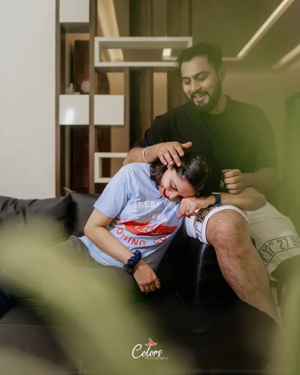 A genuinely happy and relaxed moment during an at-home photoshoot, capturing pure laughter.