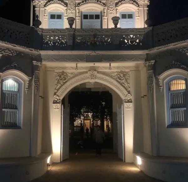 The main archway of Rhodesia House, illuminated at night. We carefully restored the ornate plasterwork and architectural details to highlight the building's unique character, creating a welcoming beacon for the Dharmaj community.