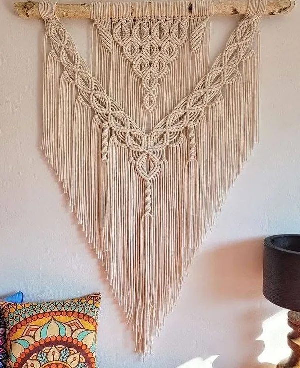 This large, V-shaped macrame wall hanging is one of my signature bohemian pieces. It's shown here in a living room, adding a beautiful, natural texture above the sofa.