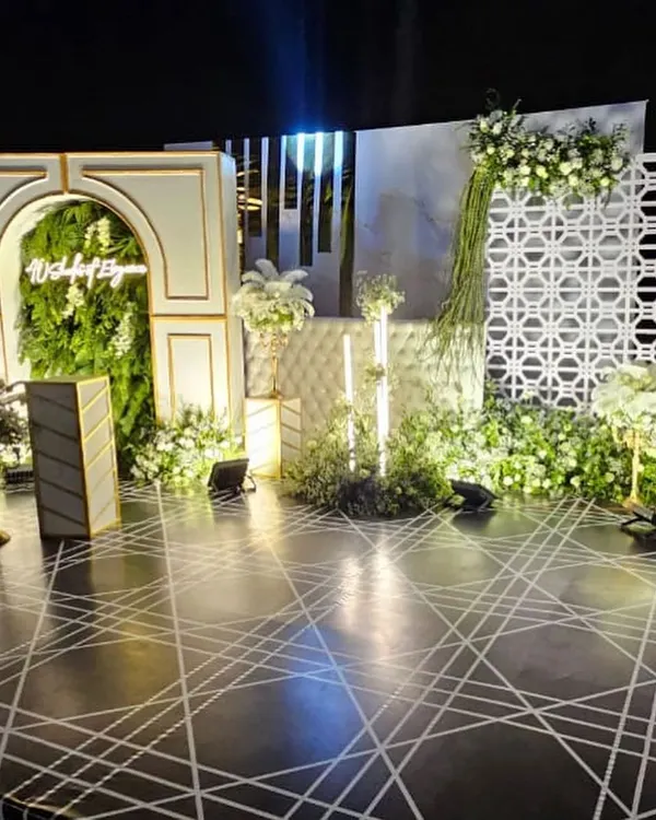 This multi-dimensional stage was the centerpiece for a sophisticated 40th birthday party. I combined architectural arches, a lush vertical garden, geometric patterns, and refined lighting to create a luxurious and modern photo-worthy backdrop.
