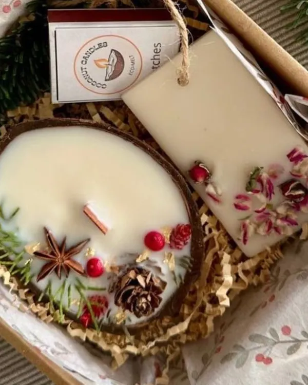 My eco-luxury gift set, featuring a coconut shell candle and a wax sachet, both adorned with dried botanicals. It's a perfect sustainable gift for Diwali or corporate hampers.