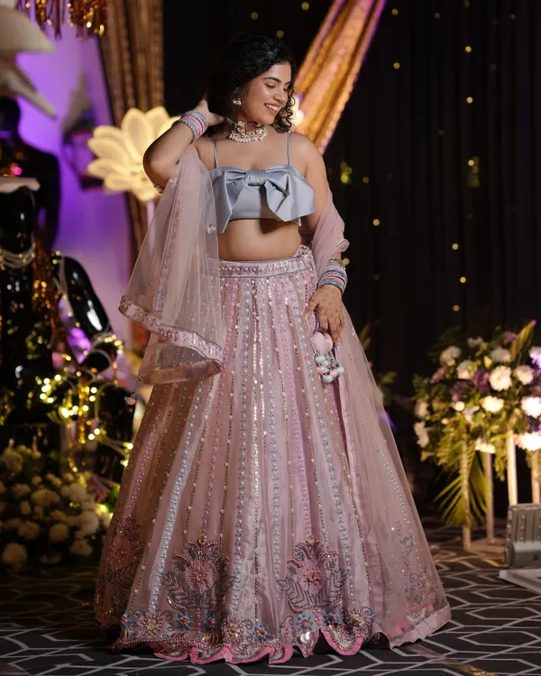 This is what I mean by making an entrance. I help you create those unforgettable 'barbie moment' looks for weddings and big events, focusing on modern silhouettes and details that feel totally you. This custom pastel lehenga with a bow blouse is perfect for a sangeet or reception.
