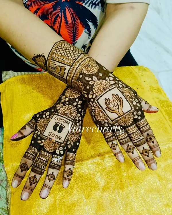 Henna hands waiting for tiny baby feet. This baby shower design features a "Coming Soon" message with little footprints and a beautiful drawing of a mother holding her hands in prayer.